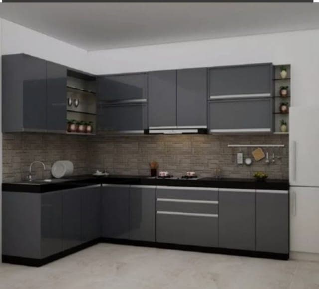 Grey L-shaped modular kitchen with stone backsplash designed by M B Interior in Bikaner